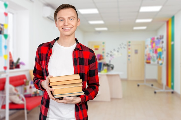 Young man holding books