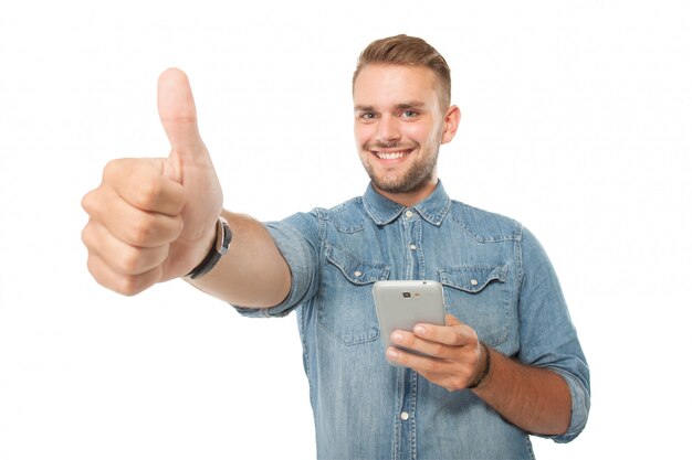 Young man holding a cellphone, thumb up