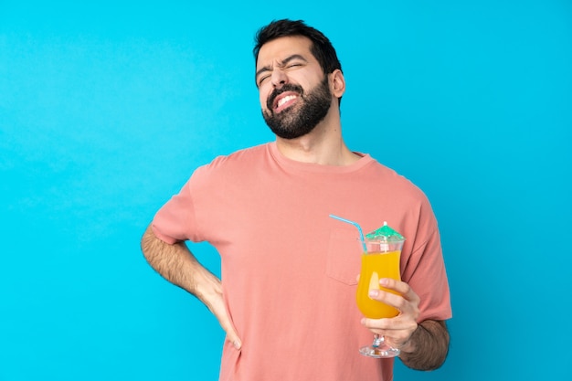 Young man over holding a cocktail suffering from backache for having made an effort