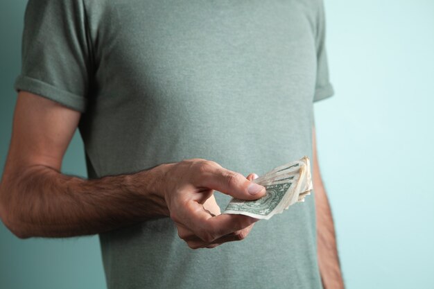 Young man holding dollar bills