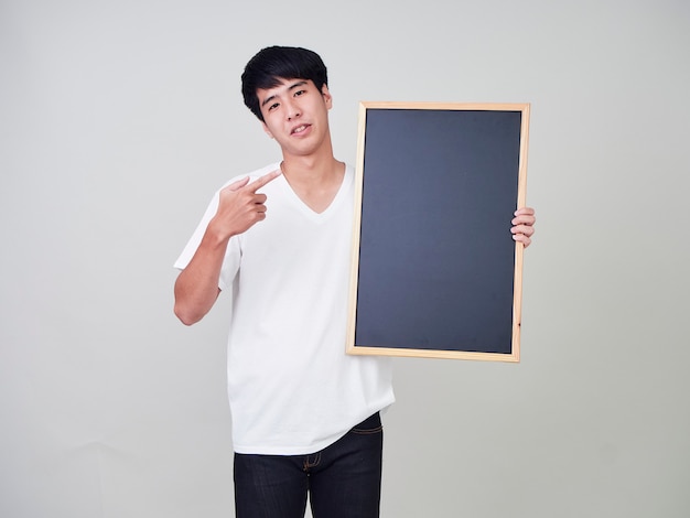 Young man holding empty blackboard