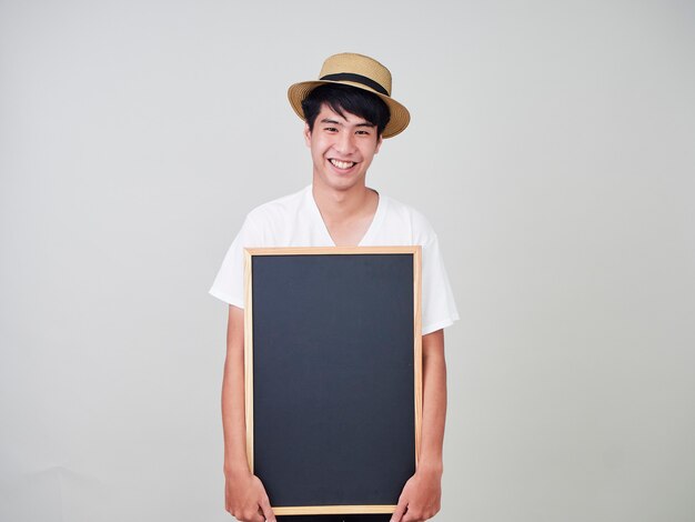 Young man holding empty blackboard