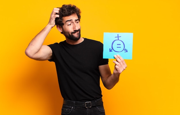 Young man holding equality paper