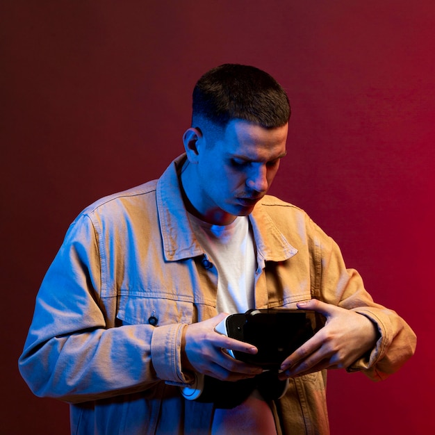 Young man holding futuristic vr goggles