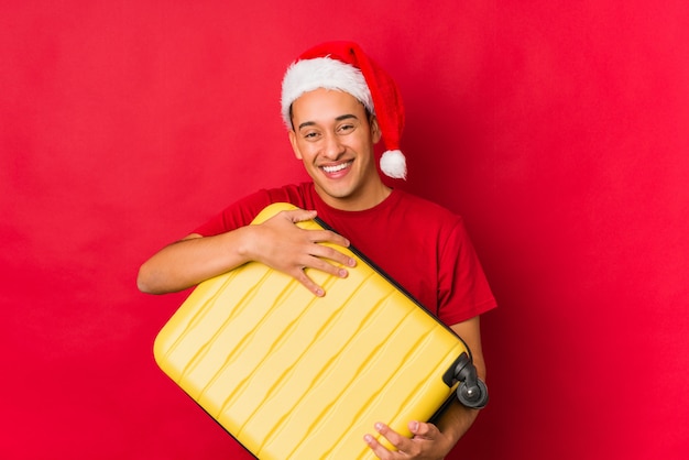 Young man holding a gift on christmas day