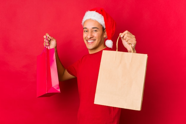 Young man holding a gift on christmas day