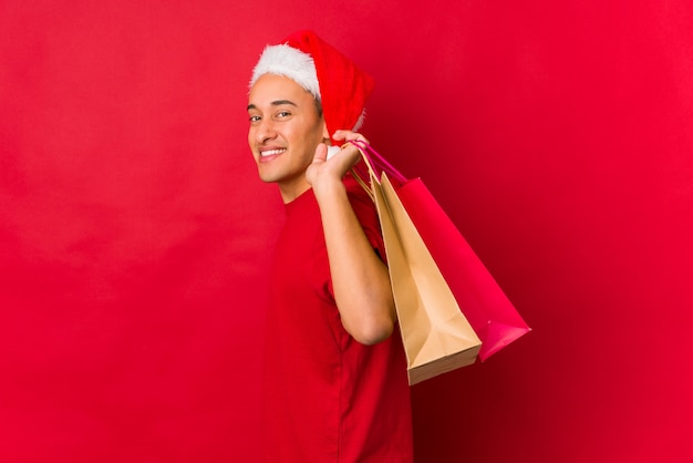 Young man holding a gift on christmas day