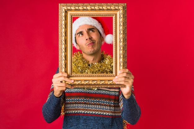 Young man holding a gift on christmas day