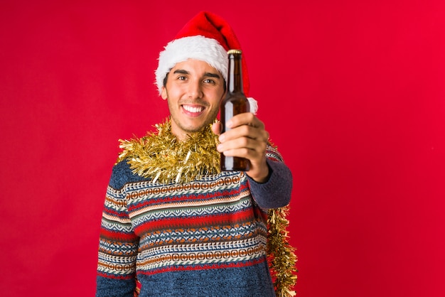 Young man holding a gift on christmas day