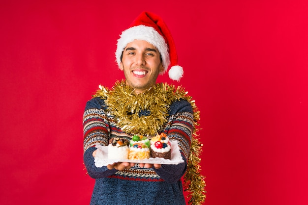 Young man holding a gift on christmas day