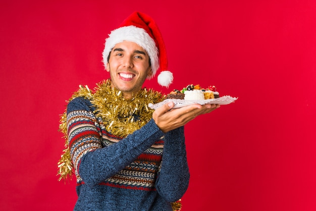 Young man holding a gift on christmas day