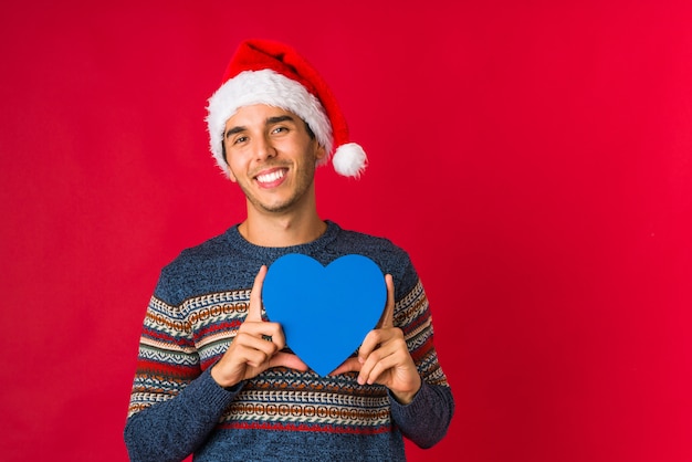 Young man holding a gift on christmas day