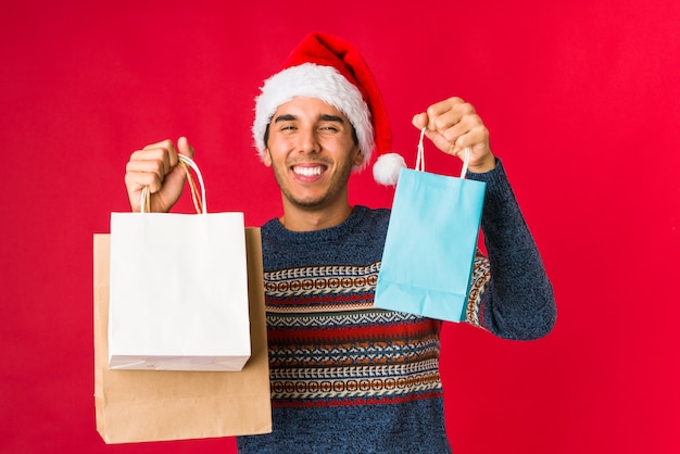 Young man holding a gift on christmas day