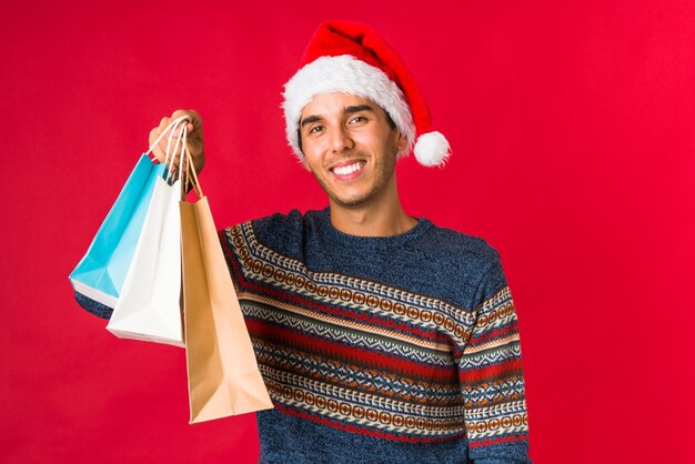 Young man holding a gift on christmas day