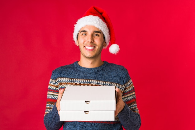 Young man holding a gift on christmas day