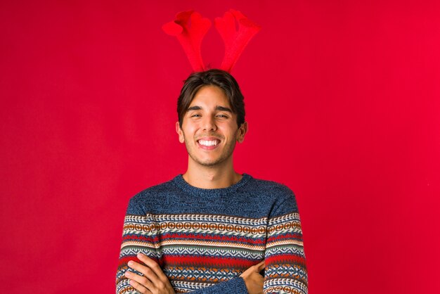 Young man holding a gift on christmas day