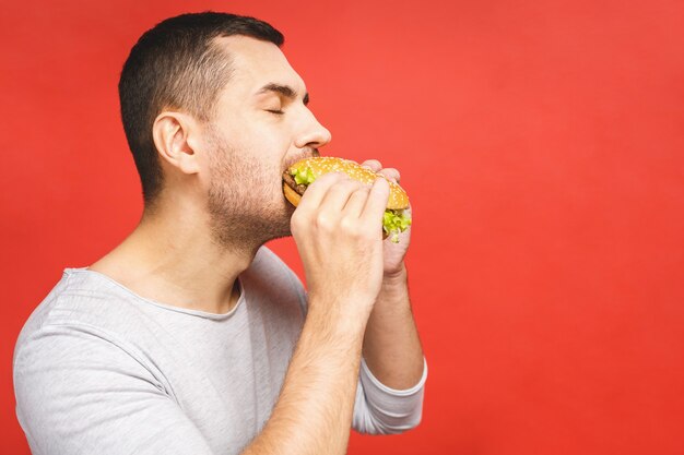 Young man holding hamburger