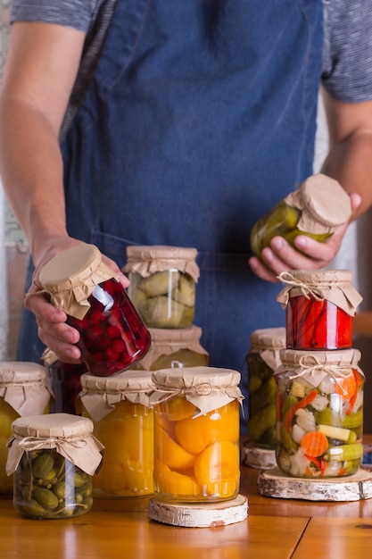 Young man holding in hands preserved food