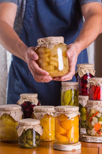 Young man holding in hands preserved food