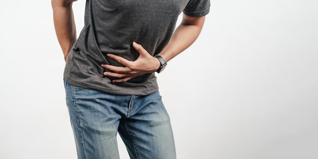 Young man holding his stomach and bottom suffering from Diarrhea incontinence prostatitis venereal