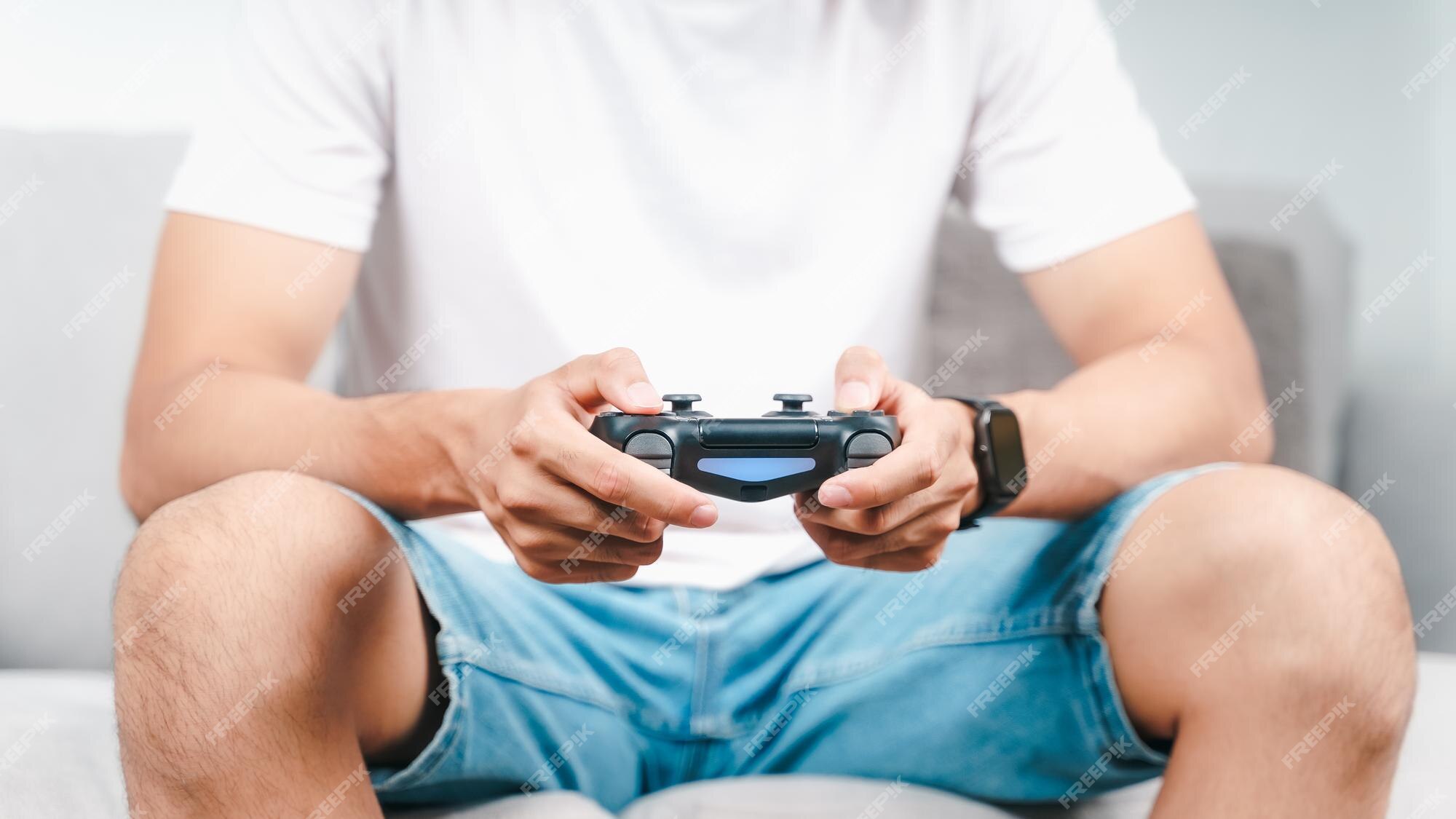 Free Photo  Person playing video games with controller on