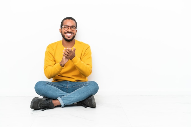 Young man holding muffin cake over isolated white background presenting and inviting to come with hand