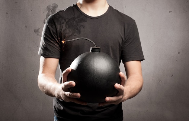 young man holding an old-fashioned bomb