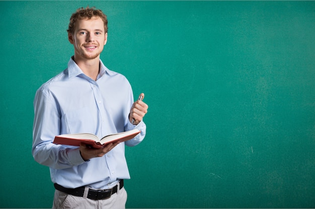 Young man holding open book