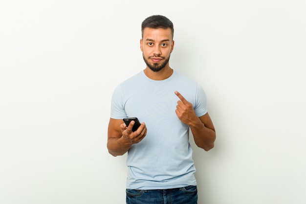 Young man holding a phone