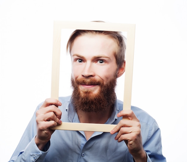 Young man holding picture frame