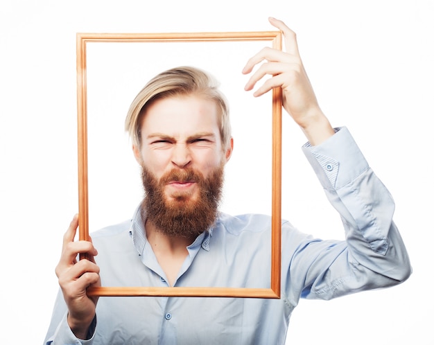 Young man holding picture frame