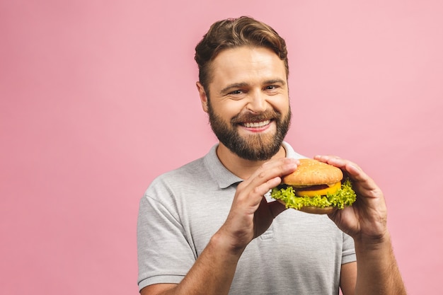 Young man holding a piece of hamburger