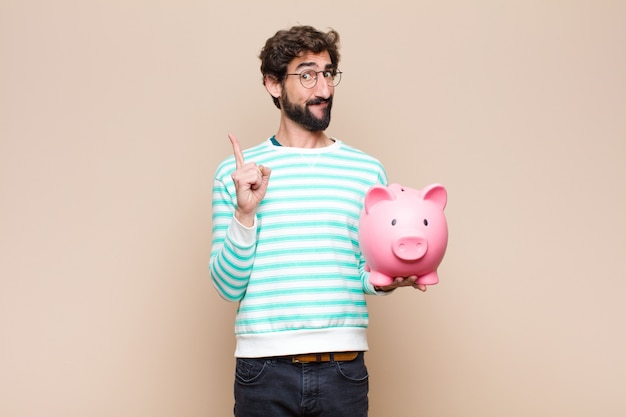 Young man holding a piggy bank