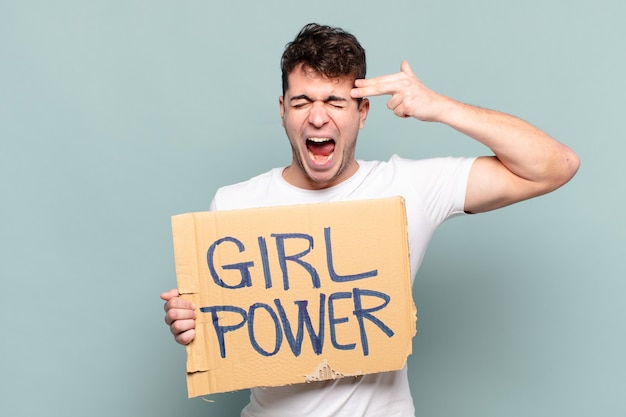 Young man holding placard with text: Girl power. Feminism concept