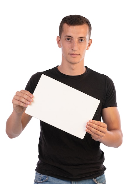 Young man holding a sign to write on it on a white background