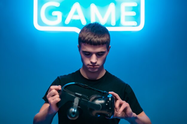 Young man holding VR glasses. Strat games. 