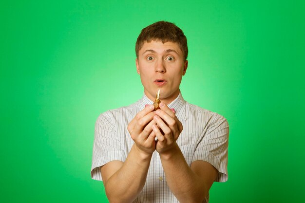 Young man holds a flower bulb