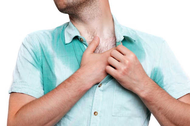 Young man in horror looking at the sweaty shirt