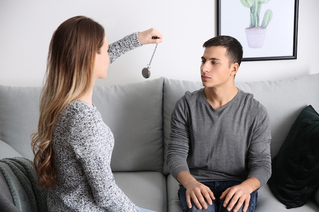 Young man during hypnosis session in psychologist's office