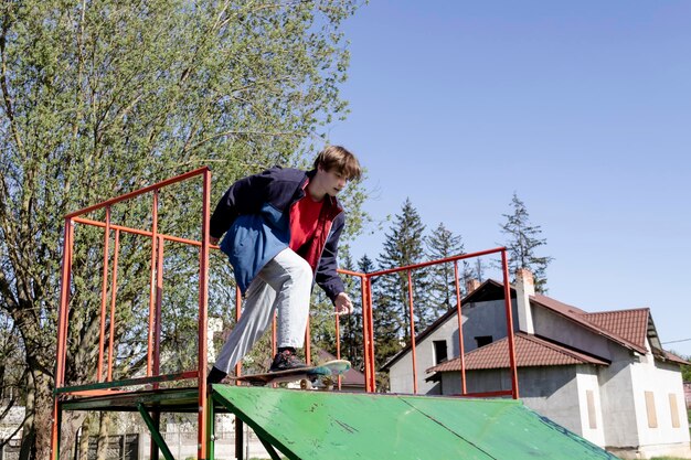 A young man is actively skateboarding alone on the street