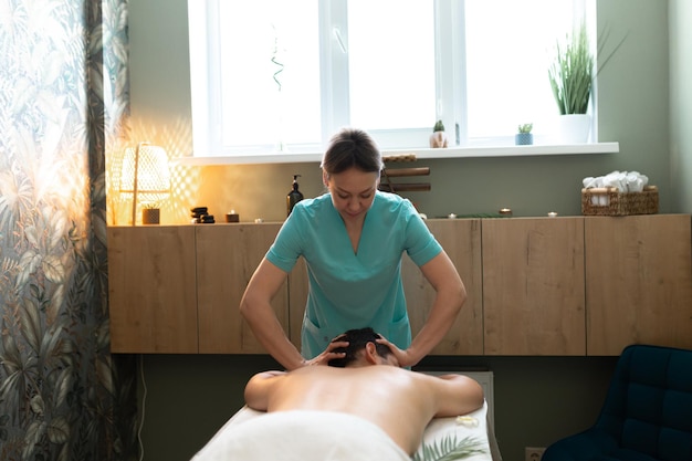 Young man is having massage on spa treatment