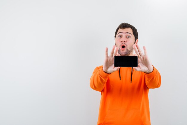 The young man is showing mockup idea on white background