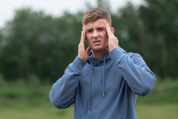 Young man is suffering from headache