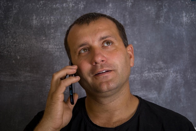 A young man is talking on the phone