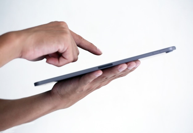 Young man is typing on tablet