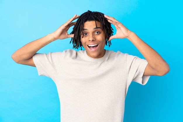 Young man over isolated blue wall