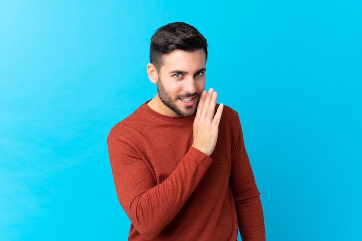 Photo young man over isolated blue wall