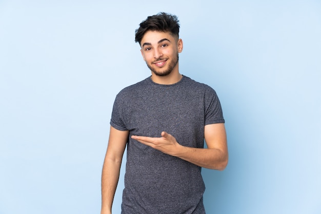 Young man isolated on blue