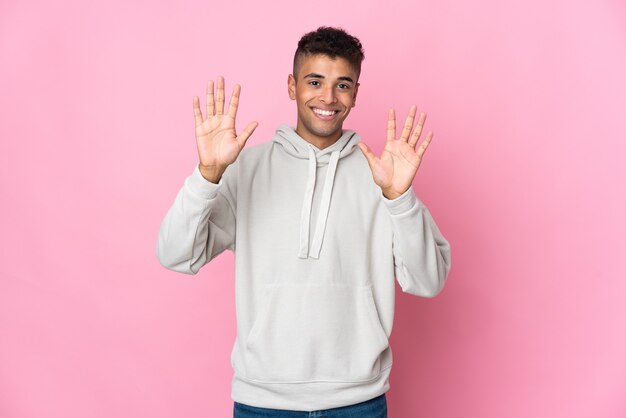 Young man isolated counting ten with fingers