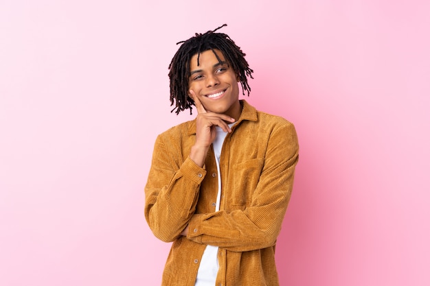 Young man over isolated pink wall